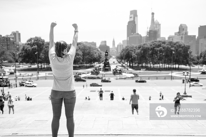 A women standing in the iconic film location of Rocky in Philidephia