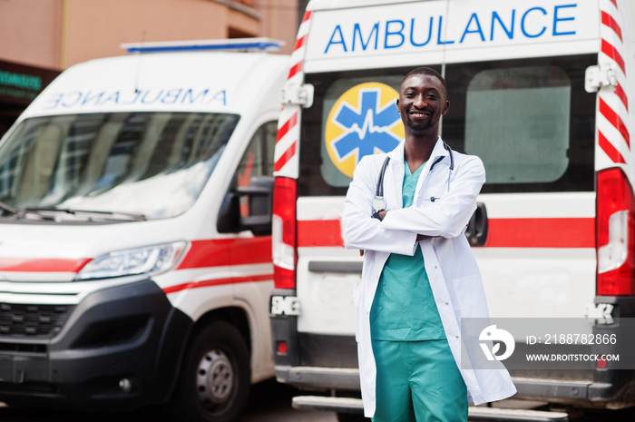 African male paramedic standing in front of ambulance car.