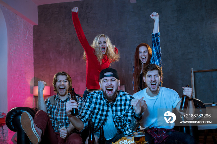 Group of friends watching TV match at home