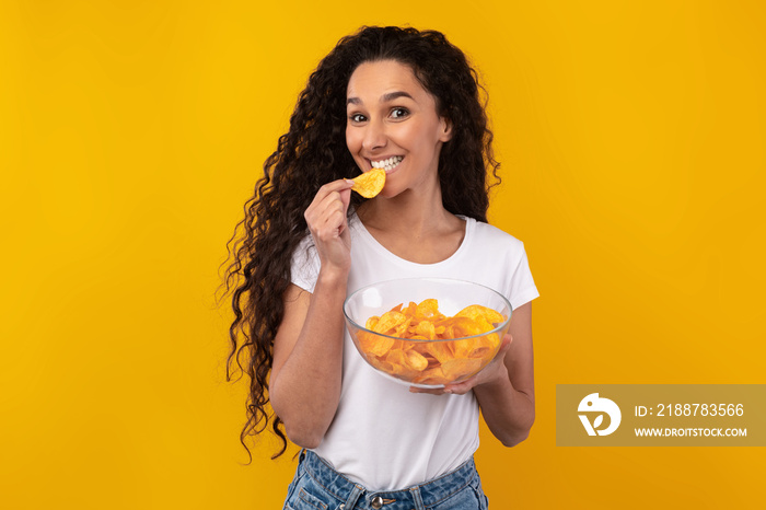 Excited Latin Lady Eating Delicious Potato Crisps