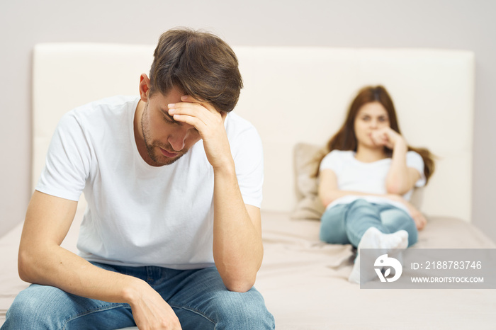 young couple sitting on sofa watching tv