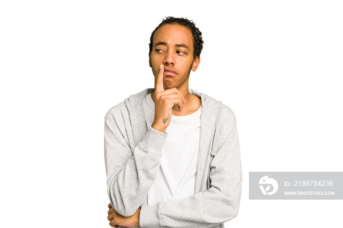 Young African American man isolated looking sideways with doubtful and skeptical expression.