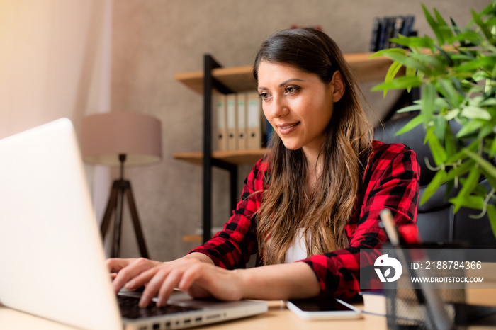 Girl teleworker works at home with a laptop