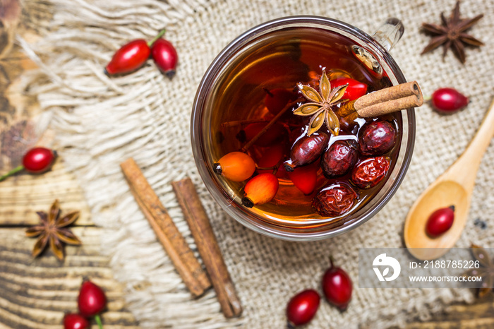 Rose hips tea on a rustic background