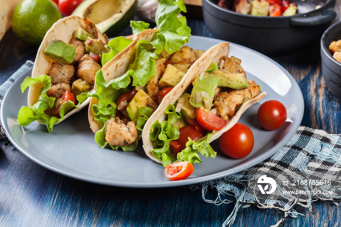 Authentic mexican tacos with chicken and salsa with avocado, tomatoes and chillies