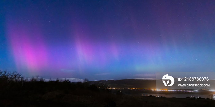 a view of the aurora borealis in the north west highlands of scotland during a clear spring night