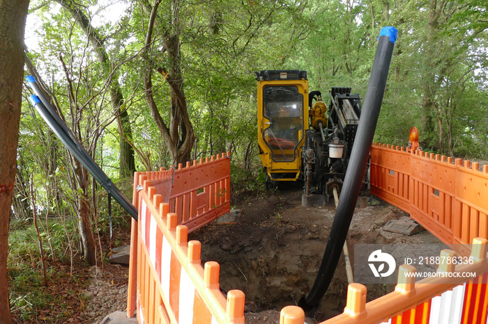 Horizontal Water Drilling Technology. Drilling machine for laying the fiber optic with hydrodrilling technology, buried cable for faster internet. Lake Berenbostel, Garbsen, Germany.