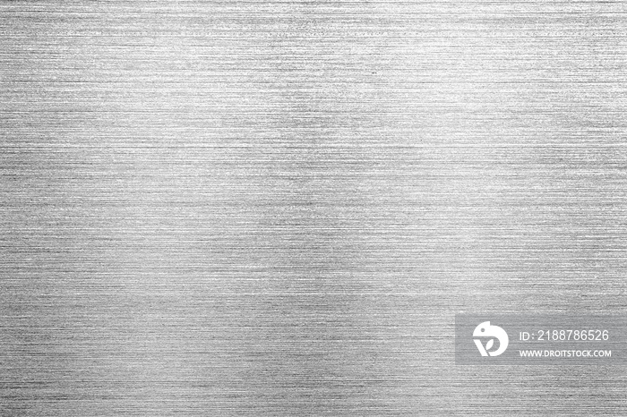 Shiny silver polished metal background texture of brushed stainless steel plate with the reflection of light.