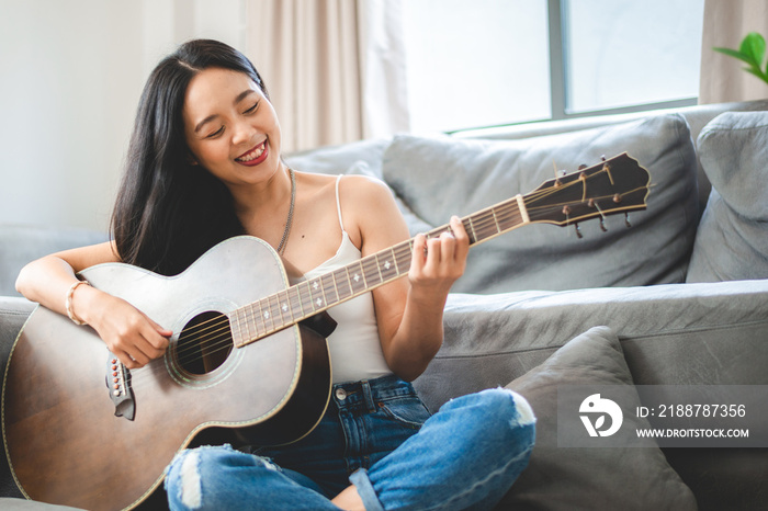 woman person playing acoustic guitar music instrument at home, young Asian musician girl lifestyle