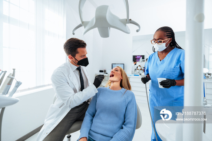 Dentist fixing adult patient teeth.