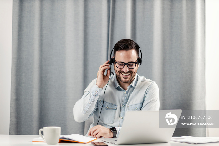 Male technical support agent working at home.