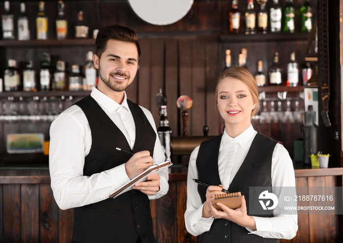 Young waiters in bar