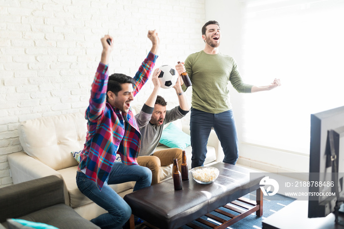 Men Having Fun While Watching Football Game At Home