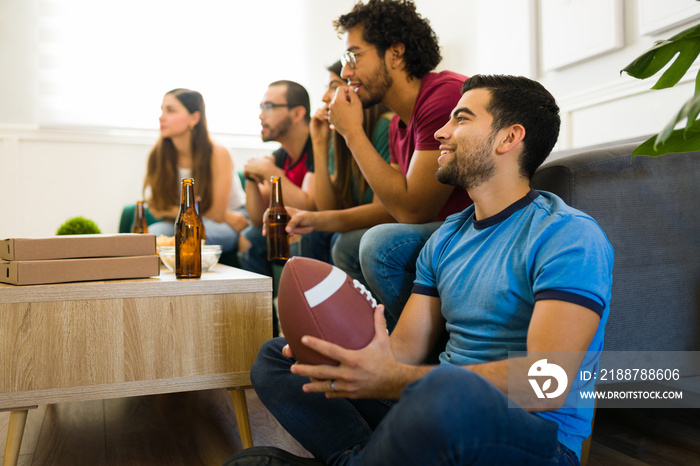 Sports fan watching with friends american football