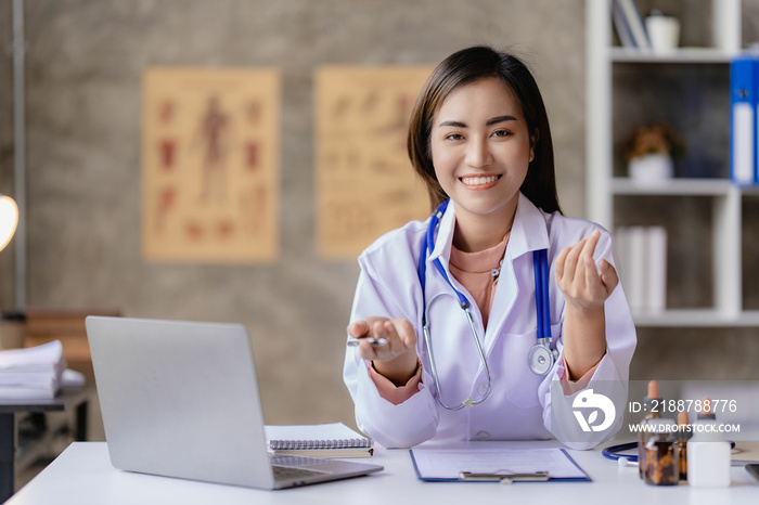 Asian female doctor working at desk with online consultation on medicines and treatments in doctor office.