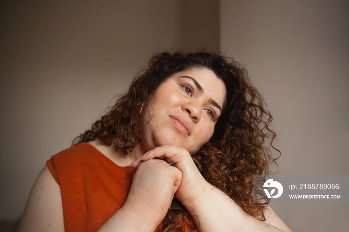 Plus-sized Sri Lankan woman with vitiligo meditating in her bedroom