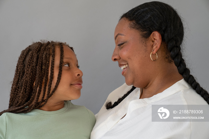 Mother smiling and looking at daughter (6-7)