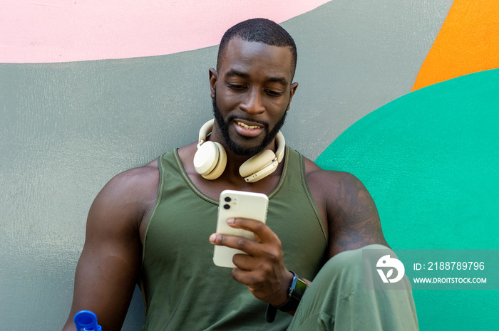 Mid adult man with headphones using phone