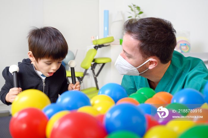 Physical therapist playing with children, with cerebral palsy. High quality photo