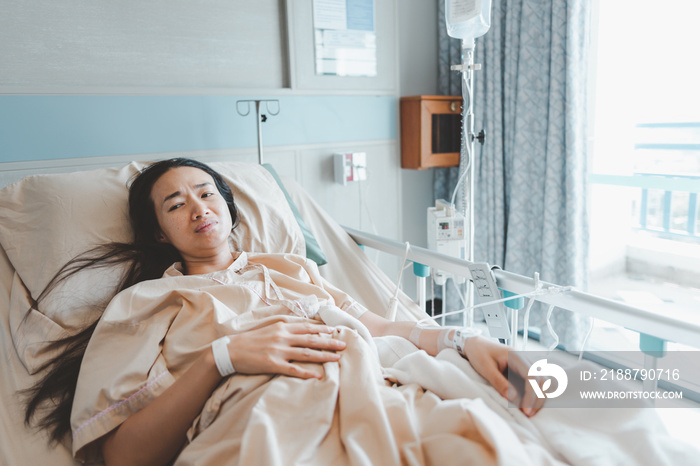 Asian woman lying on the hospital bed for admitting.Hospitalization concept.