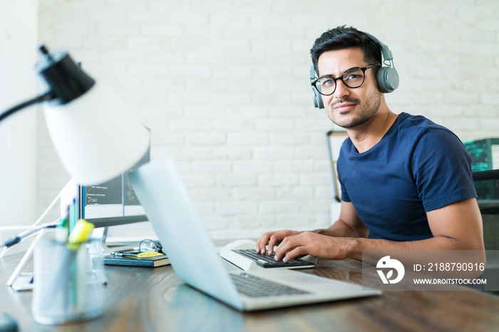 Hispanic Software Developer Tying On Keyboard