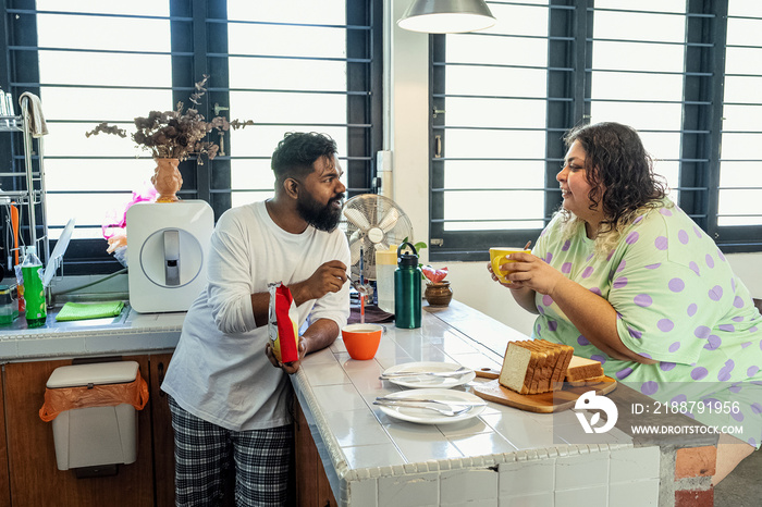 Couple making breakfast together at home in the morning