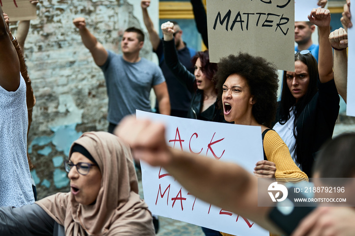 Multi-ethnic crowd of people protesting against racism public demonstrations.