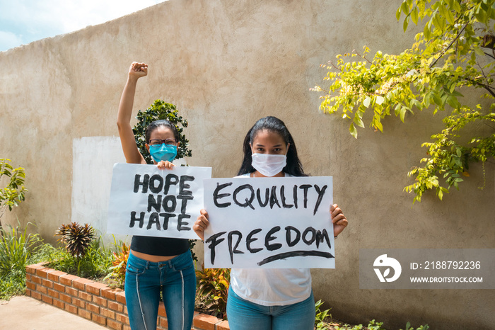 a group of black youths at a protest holding signs