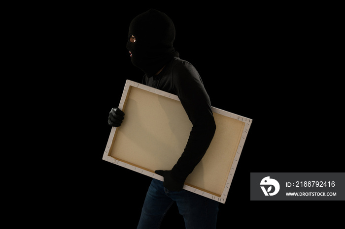 Masked thief committing art theft