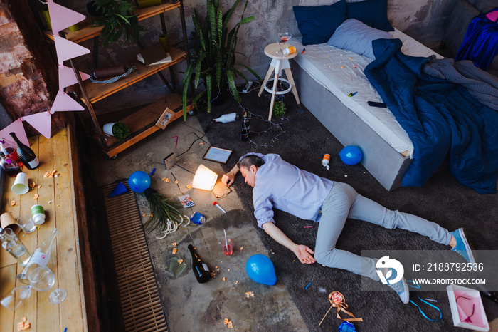 Alcohol abuse. Top view of besotted mature man lying on floor and snoring