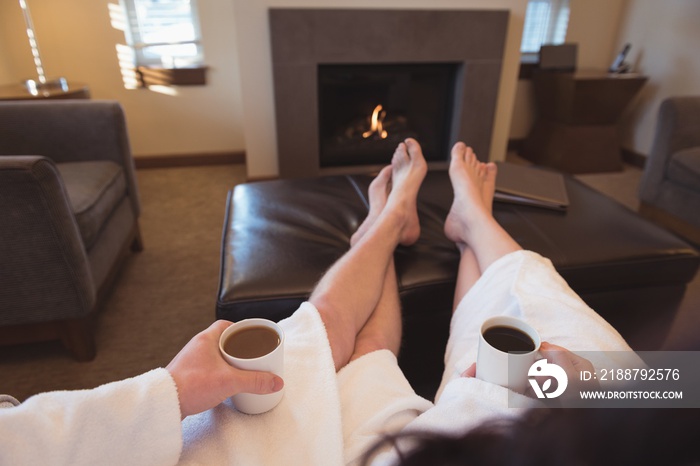 Couple relaxing while having coffee in the living room