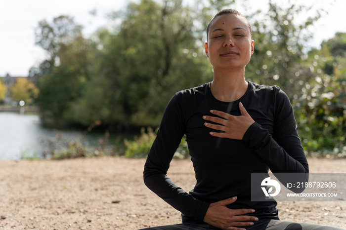 Woman meditating in park