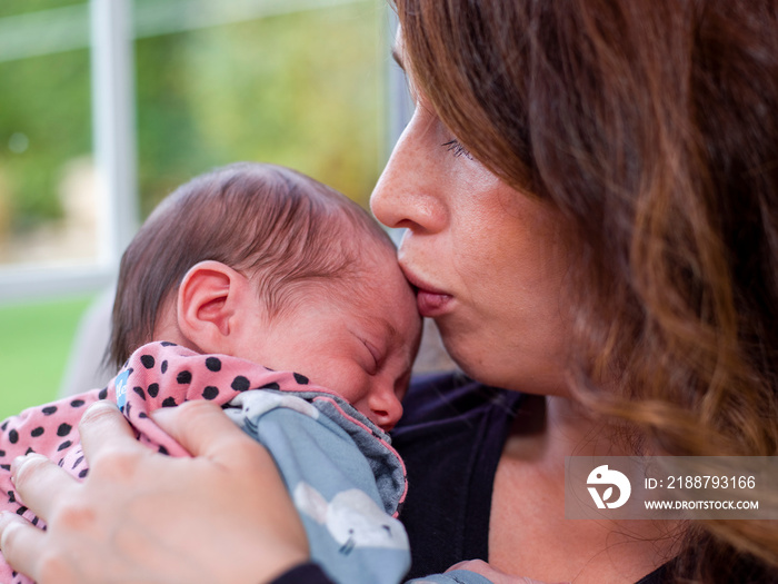 Close-up of woman kissing baby son