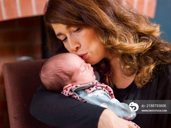 Woman kissing baby son   at home
