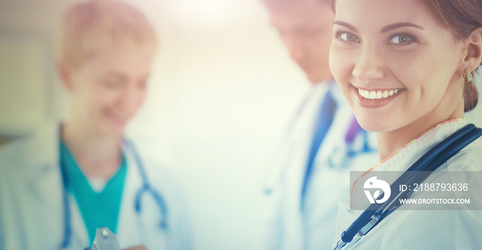 Attractive female doctor in front of medical group