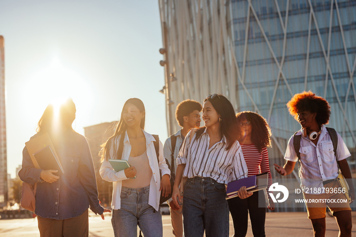 Happy students in city at sunset.