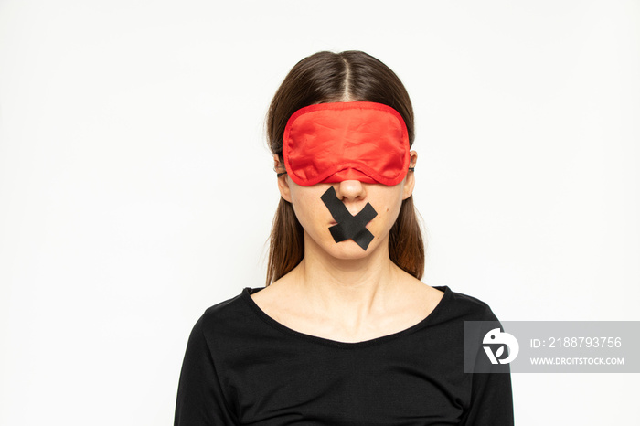 A girl with a blindfold and a closed mouth with a band-aid on an isolated background, a blind and dumb