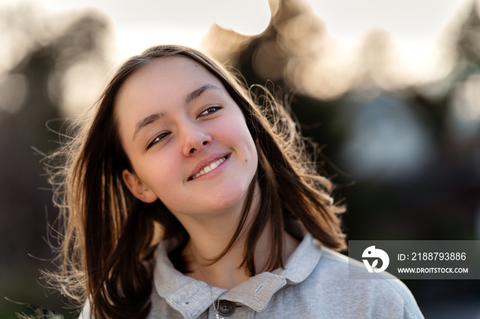 Generation Z. Close up portrait of happy smiling tween girl outdoors. Teenager girl with trendy eyes makeup, natural beauty and tenderness of youth.