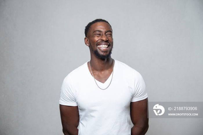 Portrait of laughing man with closed eyes