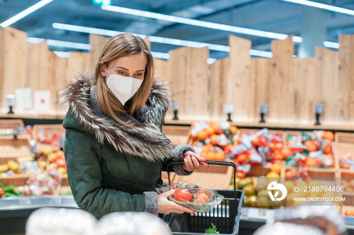 Woman wearing ffp2 face mask shopping groceries in supermarket