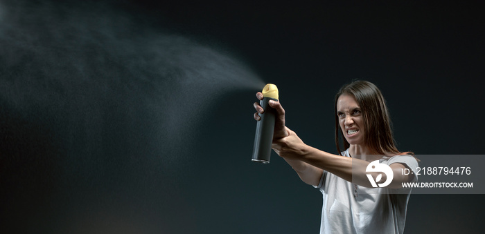 Aggressive woman spraying insect repellent