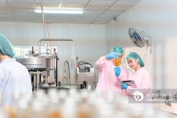 A quality supervisor or food or beverages technician discuss about process control of food and drugs before send product to the customer. Production leader recheck ingredient and productivity.