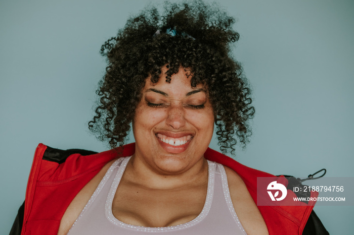 closeup portrait of a plus size afro indigenous person smiling