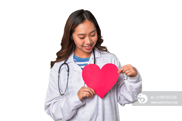 Healthy heart in the hands of a young female doctor