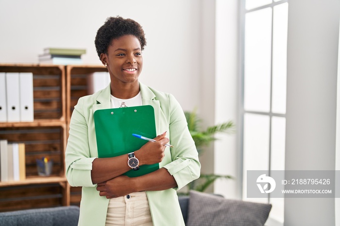 African american woman psychologist holding clipboard at psychology center