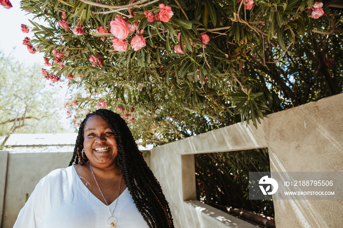 portrait of a plus size afro latinx haitian american smiling under a tree