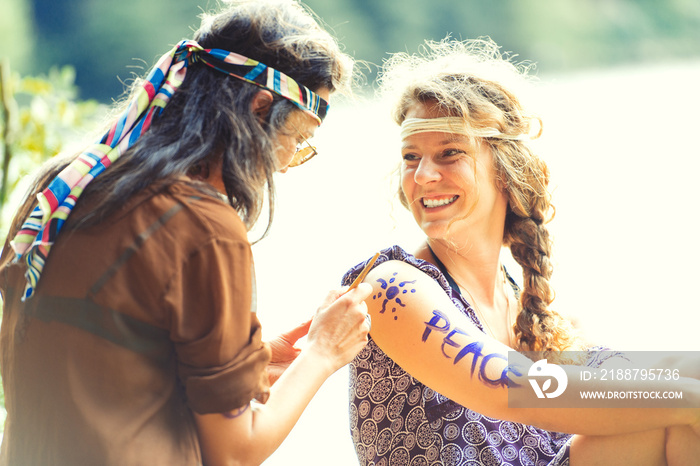 Pretty free hippie girls. Body painting - Vintage effect photo