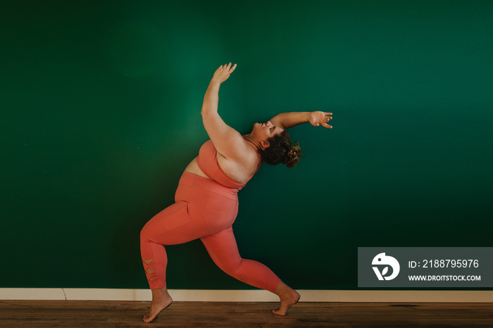 plus size person stretches and dances