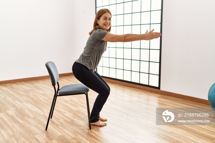 Middle age caucasian woman smiling confident training at sport center