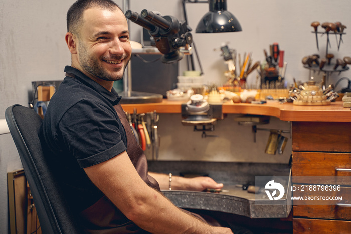 Joyous bearded craftsman smiling at the camera